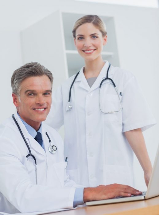 Medical team smiling in the office at desk